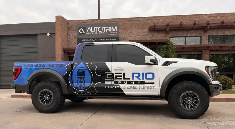 Del Rio Pump Ford Raptor in a blue and white commercial wrap