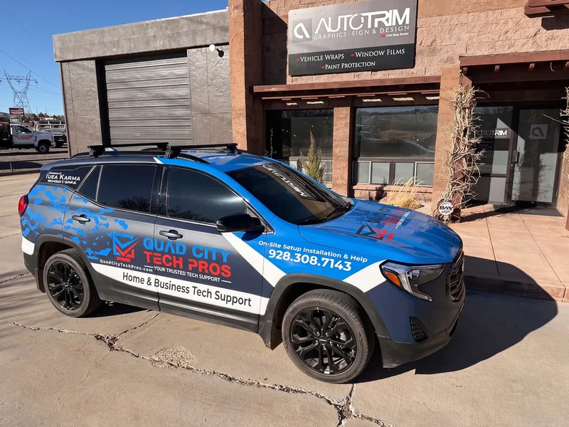 Quad City Tech Pros SUV in a blue and white partial wrap