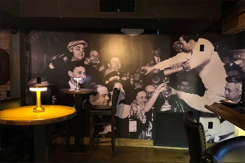A printed photo mural covering the back wall of a bar dining room