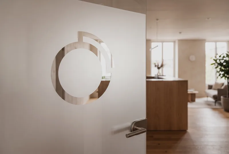 Glass office door with a logo cut out of the frosted film
