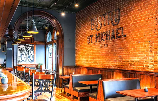 Bistro St Michael brick wall carrying a painted-style logo