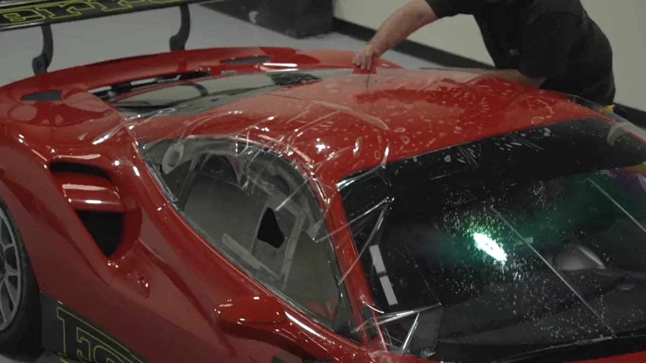 A Ferrari receiving paint protection film at Auto Trim Plus