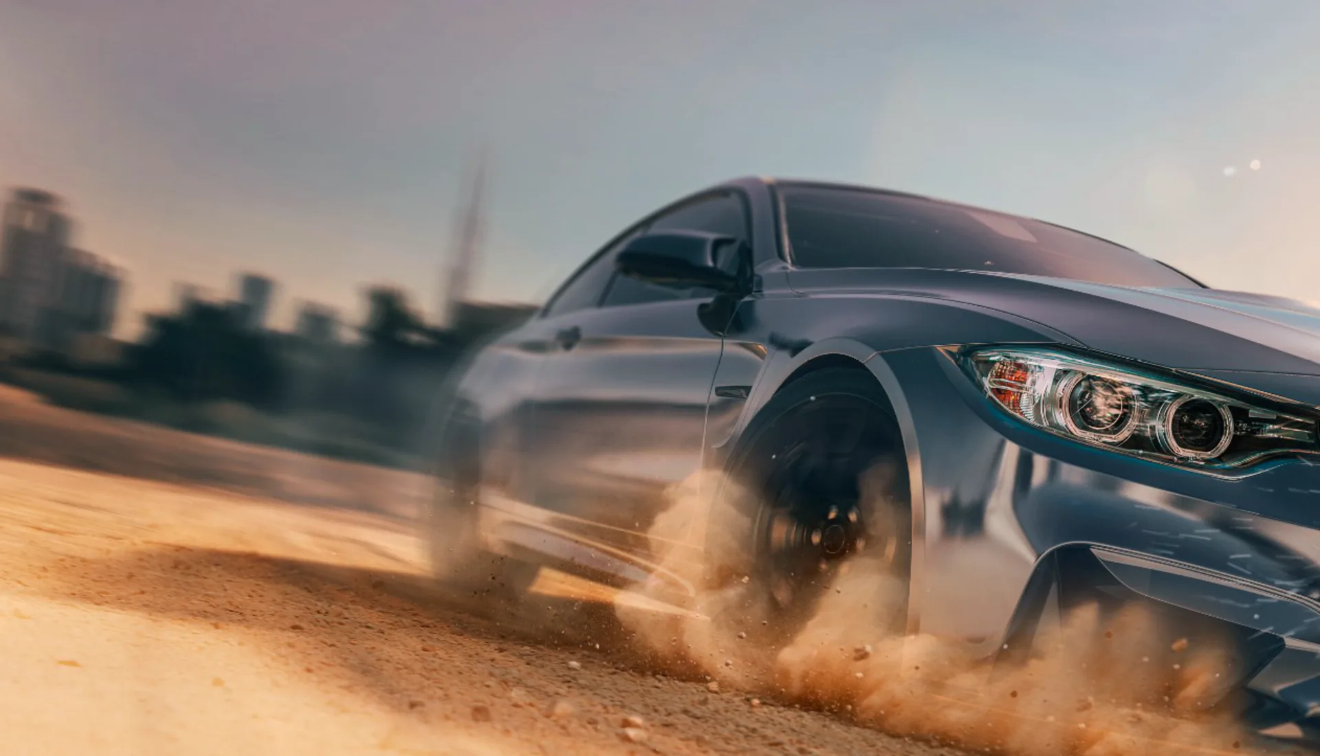 A coupe finished in protective film, driven hard on a dirt road