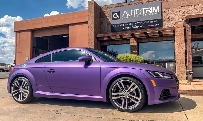 Audi TT in a purple color-change wrap outside the Auto Trim Plus shop
