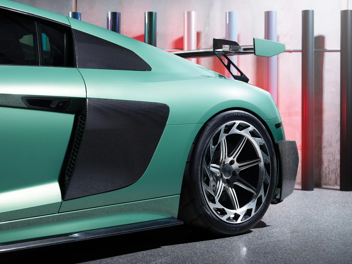An Audi R8 wrapped in 3M Protection Wrap Film, Gloss Iridescent Emerald Green, with carbon side blades