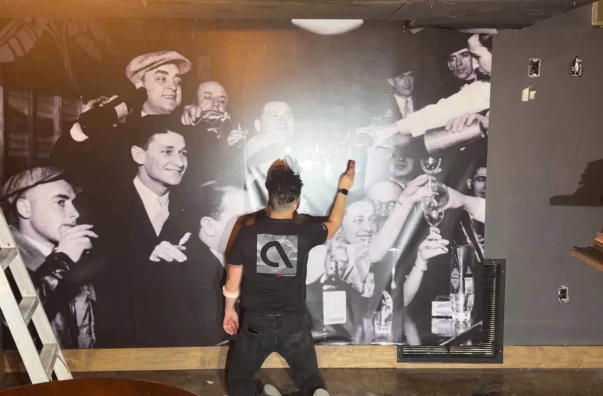 An installer applying a wall mural